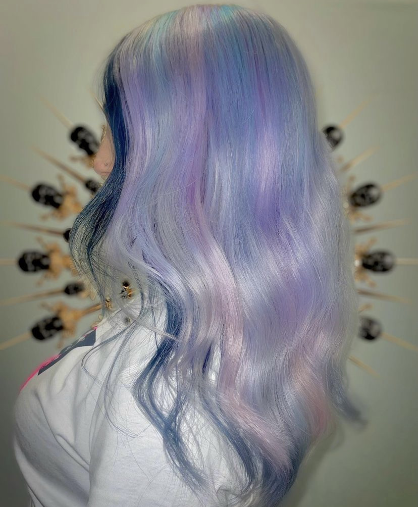 side profile of woman with long silver, blue and lilac hair