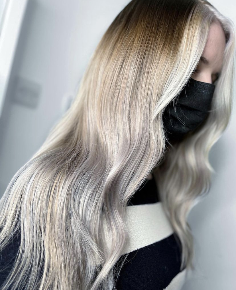 side view of womans long blonde and silver hair