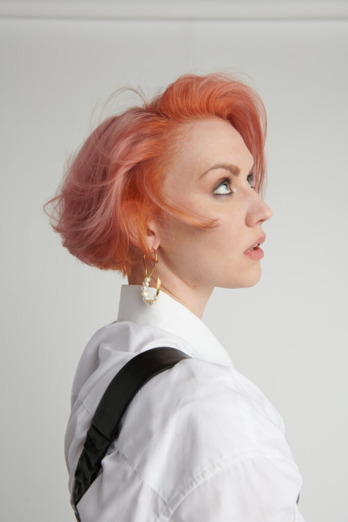 side profile of woman with short peach coloured hair