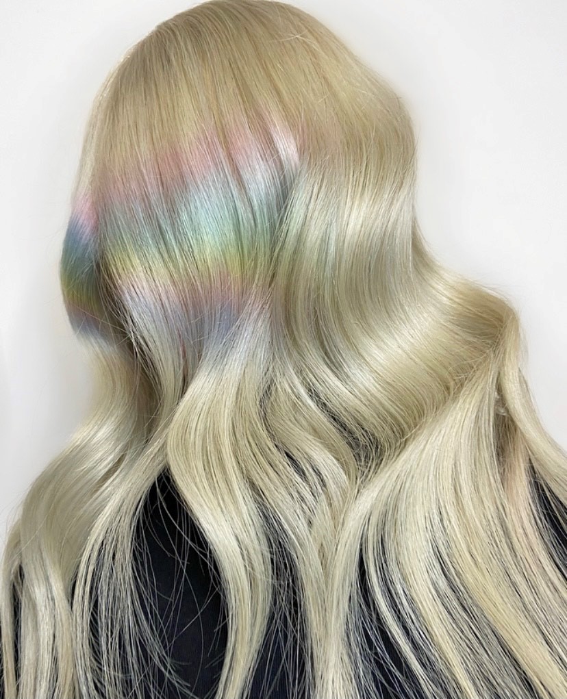 back of womans head with blonde hair and iridescent section