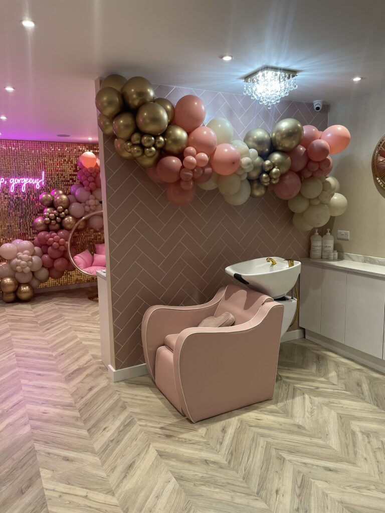 in salon backwash station with balloon wall