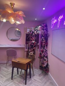 pink salon interior with seating area and desk