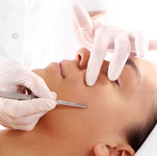 A picture of a woman receiving a dermaplanning treatment